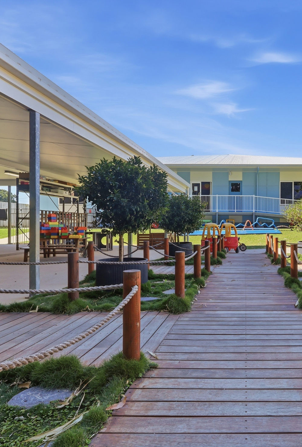 Timber boardwalk through the outdoor playscape at Walkerston Early Learning Centre